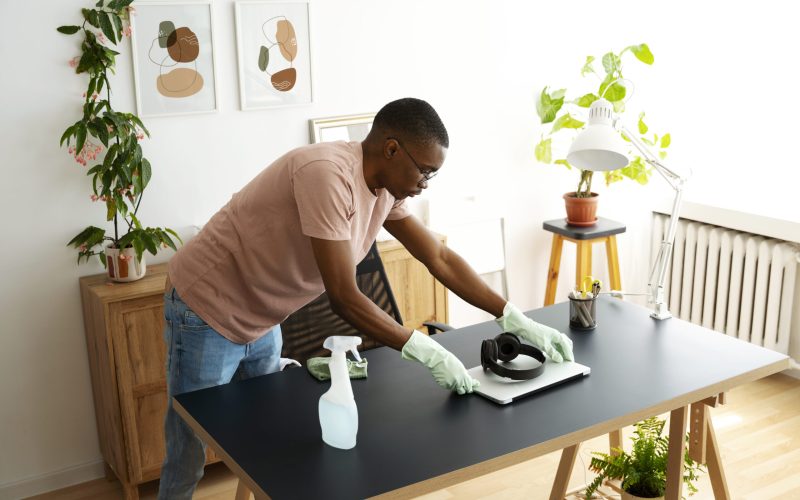 high-angle-man-cleaning-table